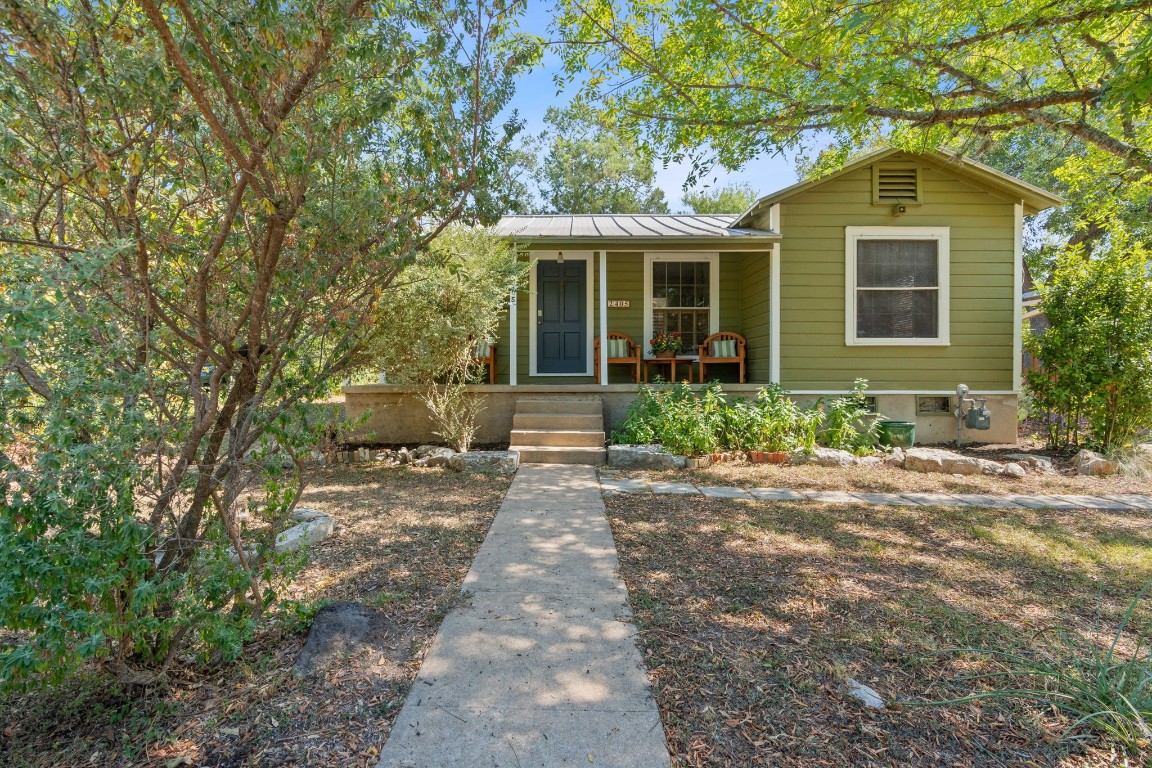 a front view of a house with garden