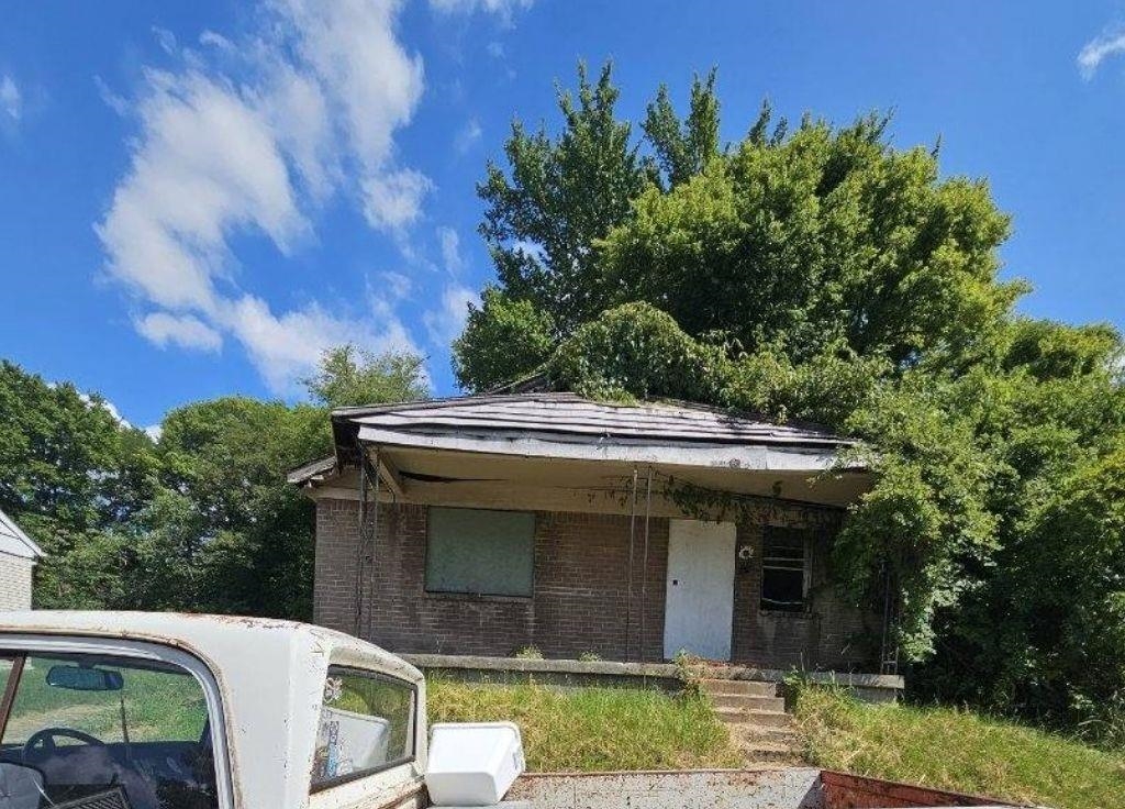 a view of a white house with a sink and yard