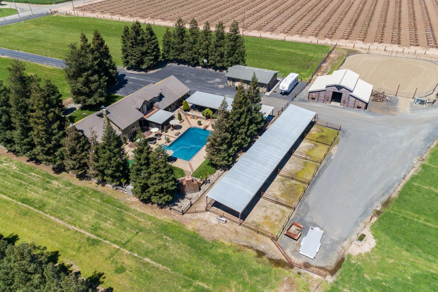 an aerial view of a house with a swimming pool