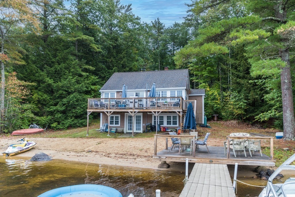 an aerial view of a house with swimming pool and sitting area