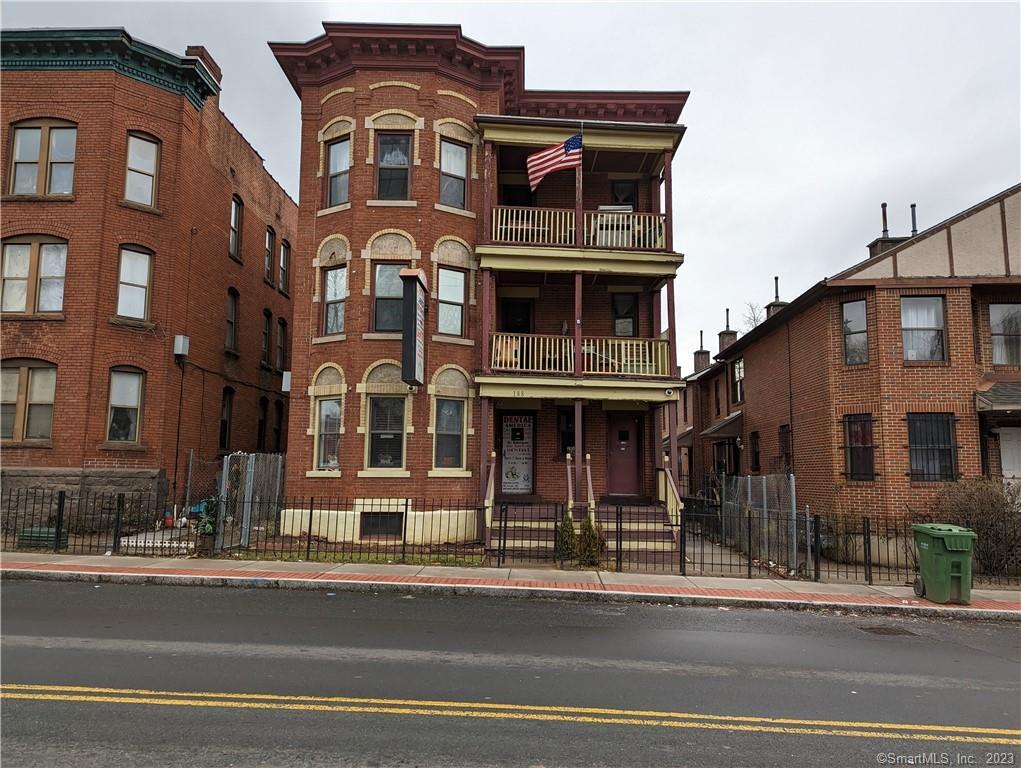 a front view of a building and car parked