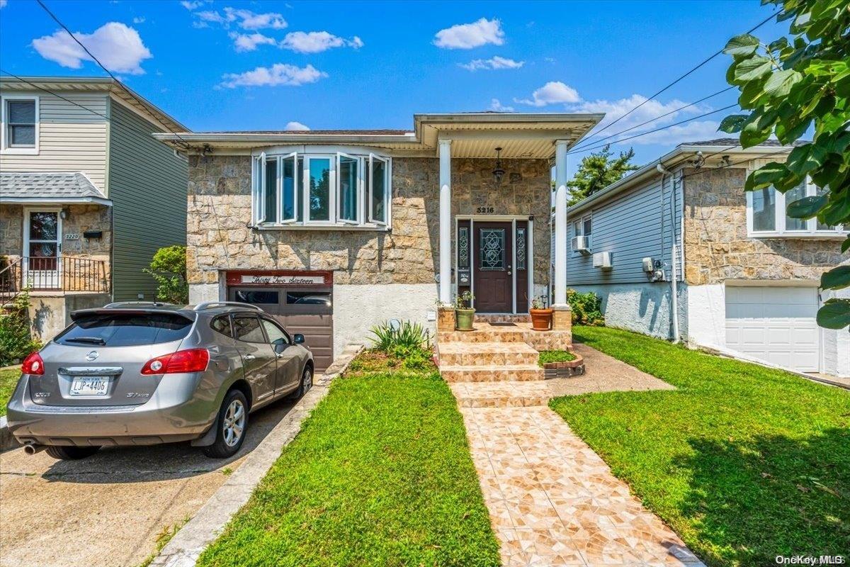 a front view of a house with a garden and patio