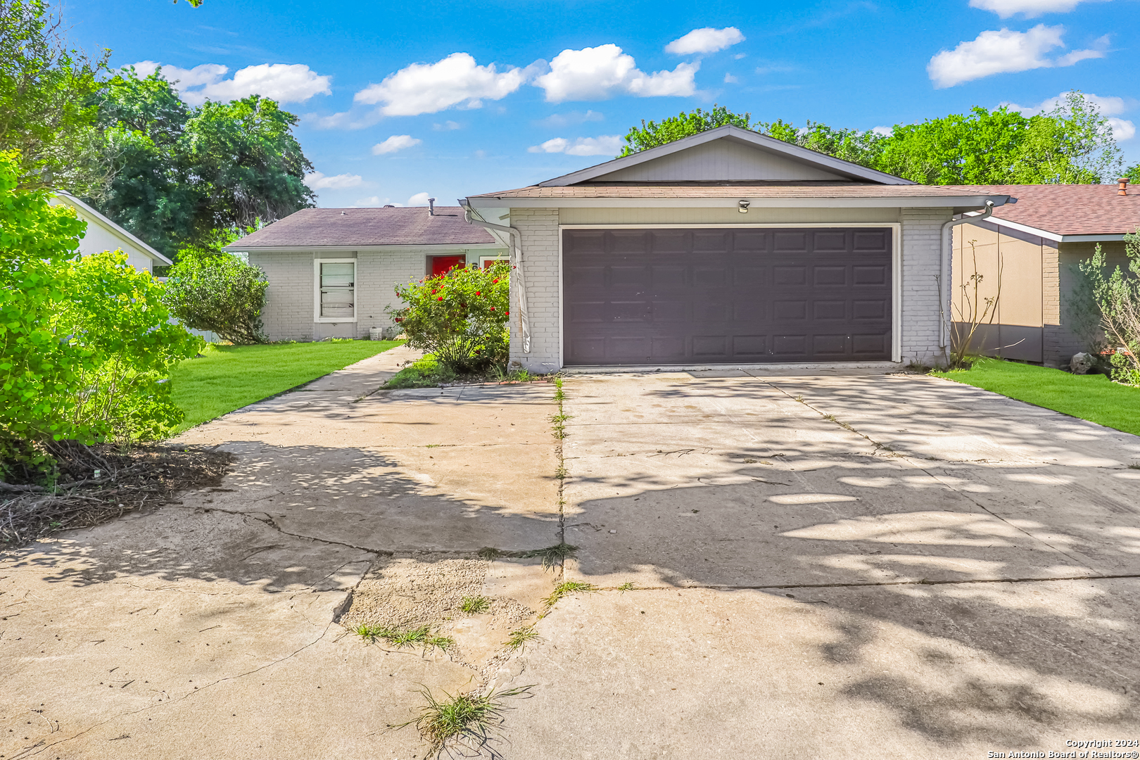 a front view of a house with a yard and garage