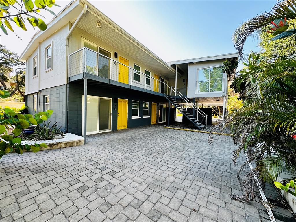 a view of a house with backyard porch and sitting area