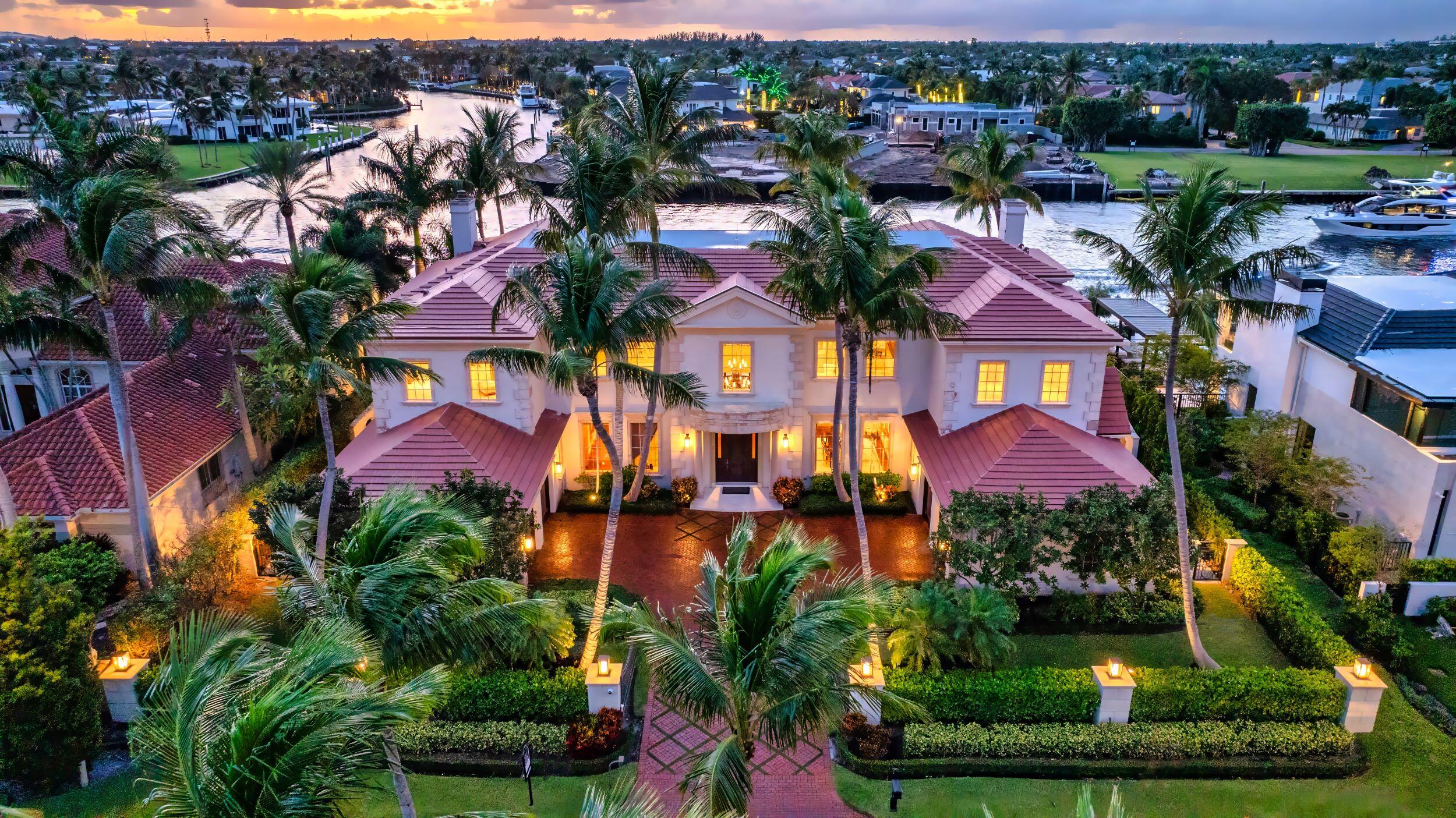 an aerial view of multiple houses with a yard