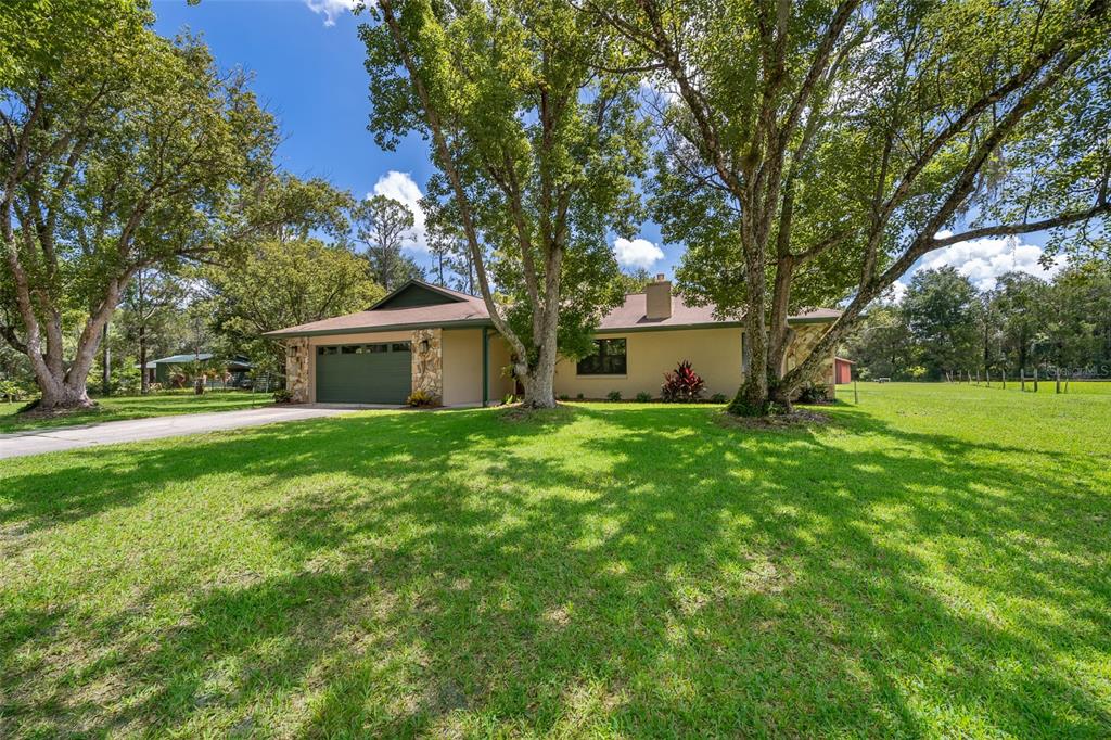 a front view of house with yard and green space