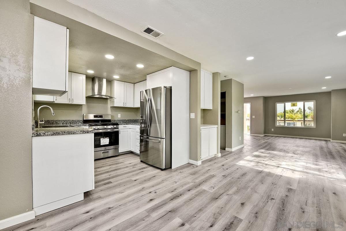 a kitchen with refrigerator and window