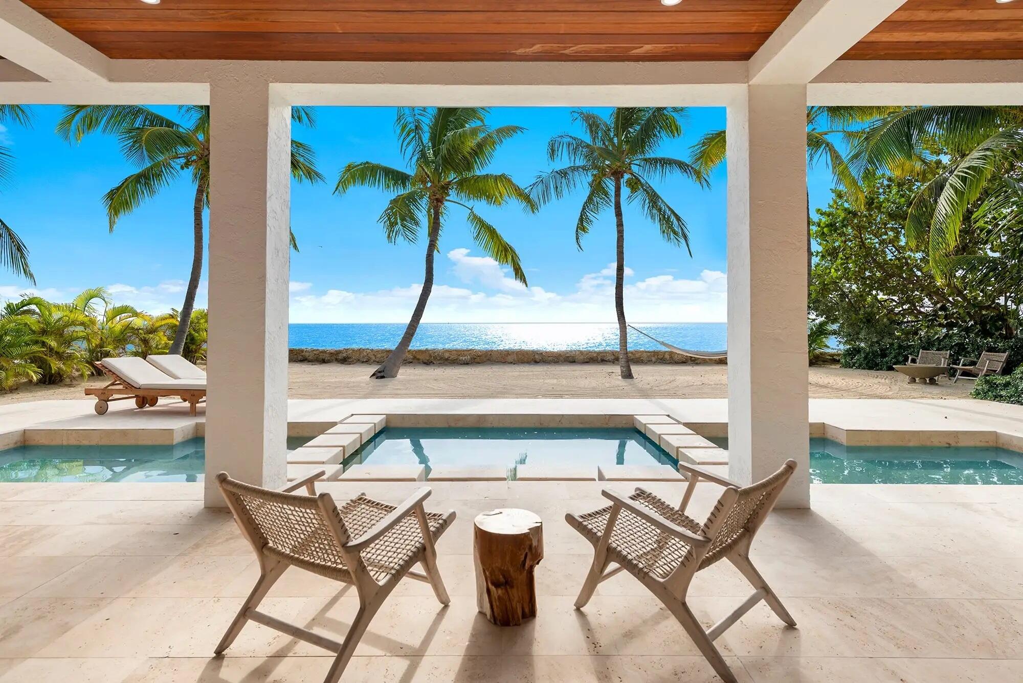 a view of a patio with a table and chairs potted plants