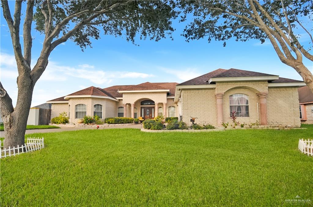 a front view of a house with a garden