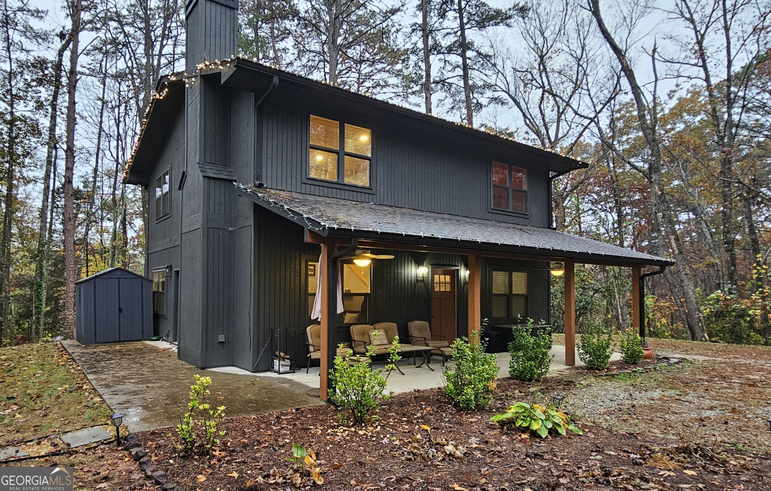 a view of a house with backyard porch and sitting area