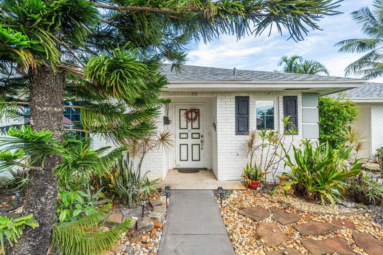 a front view of a house with a garden