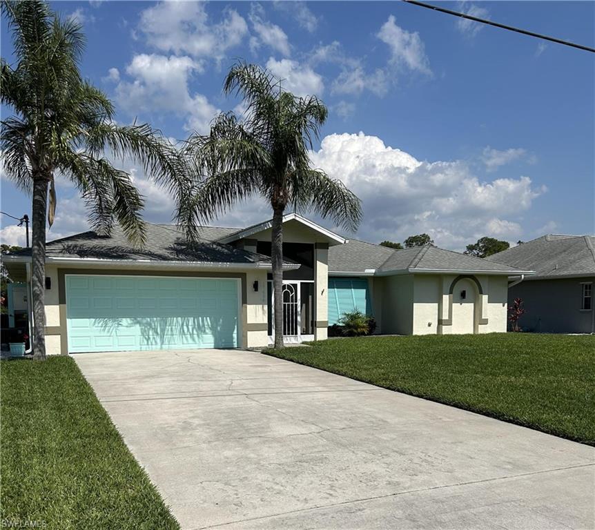 a front view of a house with a garden and yard