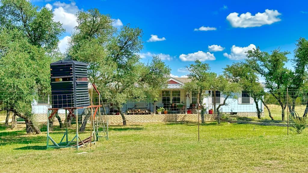 a view of a house with a backyard