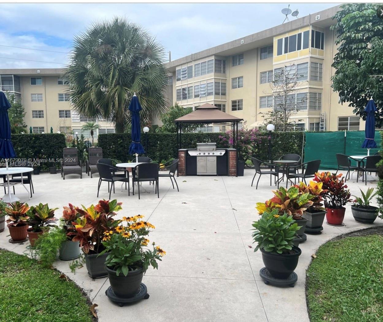 a view of a patio with couches table and chairs potted plants