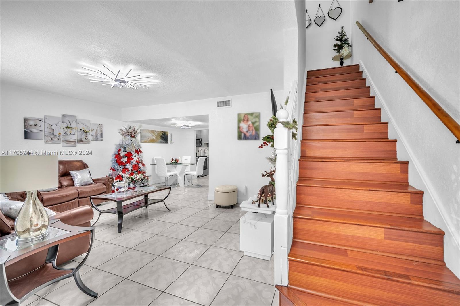 a living room with furniture and stairs