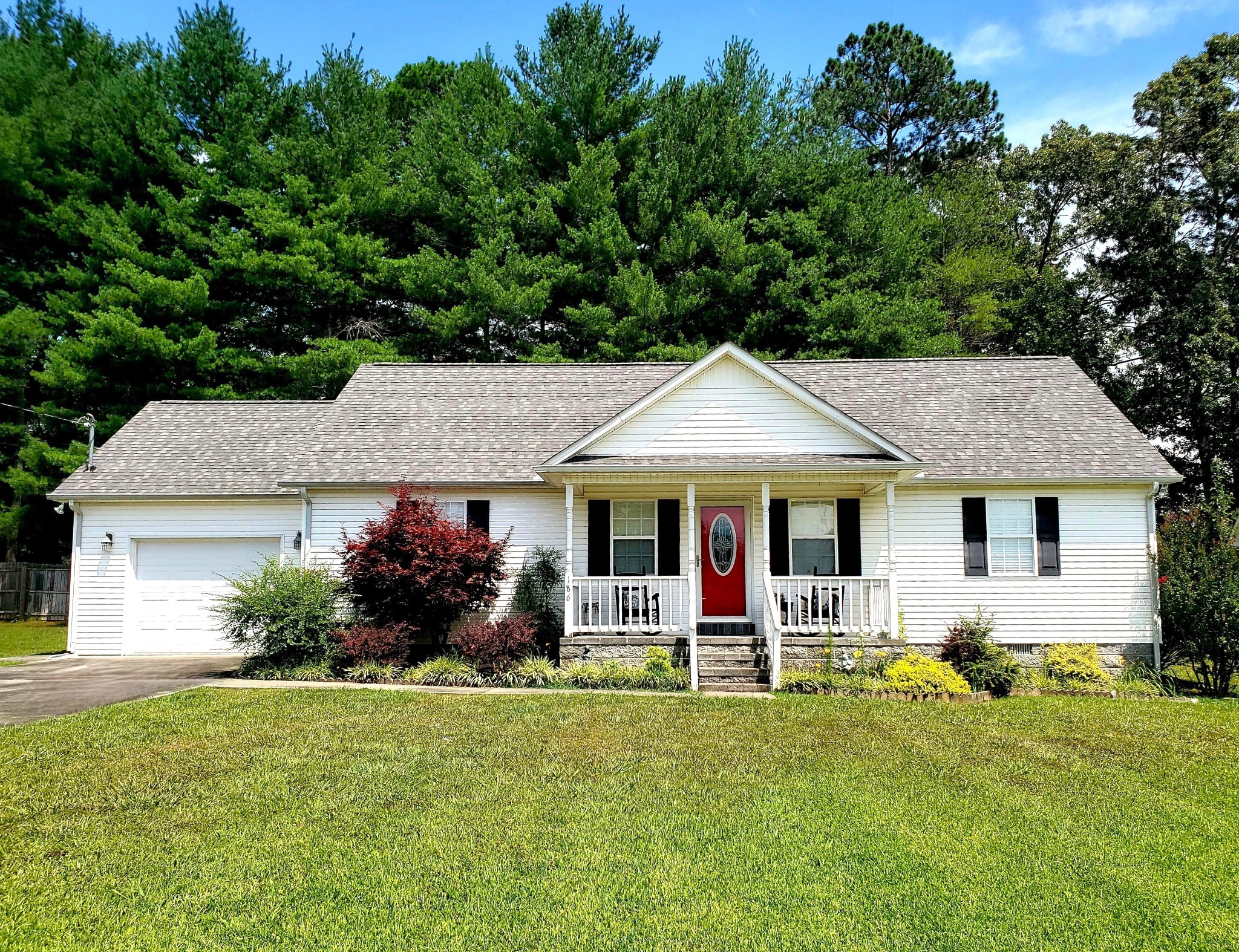 a front view of house with yard and green space