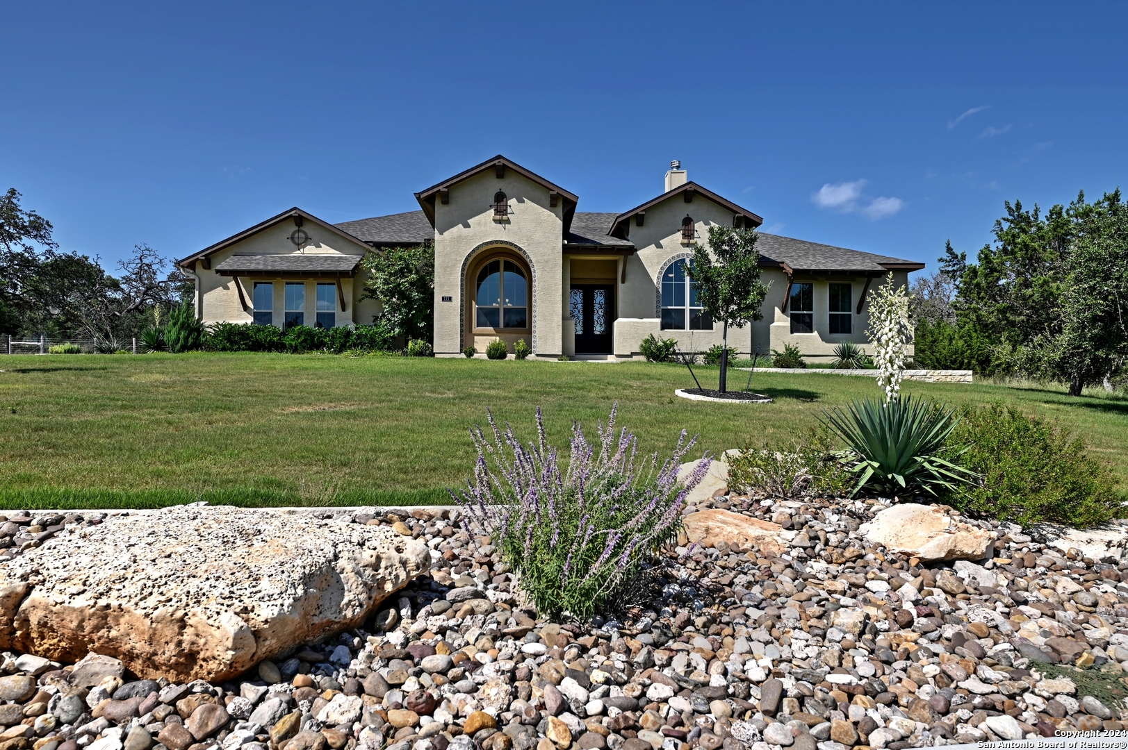 a front view of a house with garden