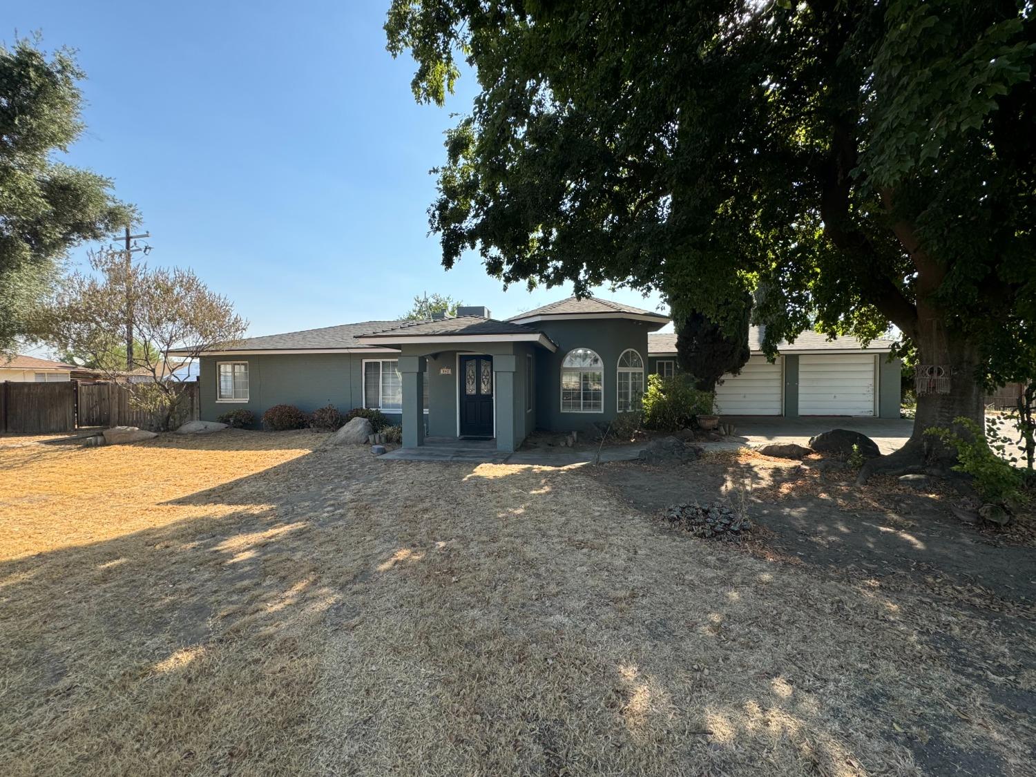 a view of a house with a yard and tree s