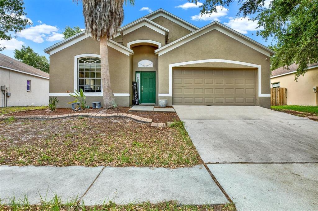 a front view of a house with a yard and garage