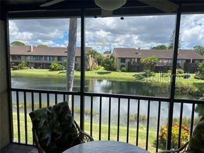 a view of a balcony with a yard