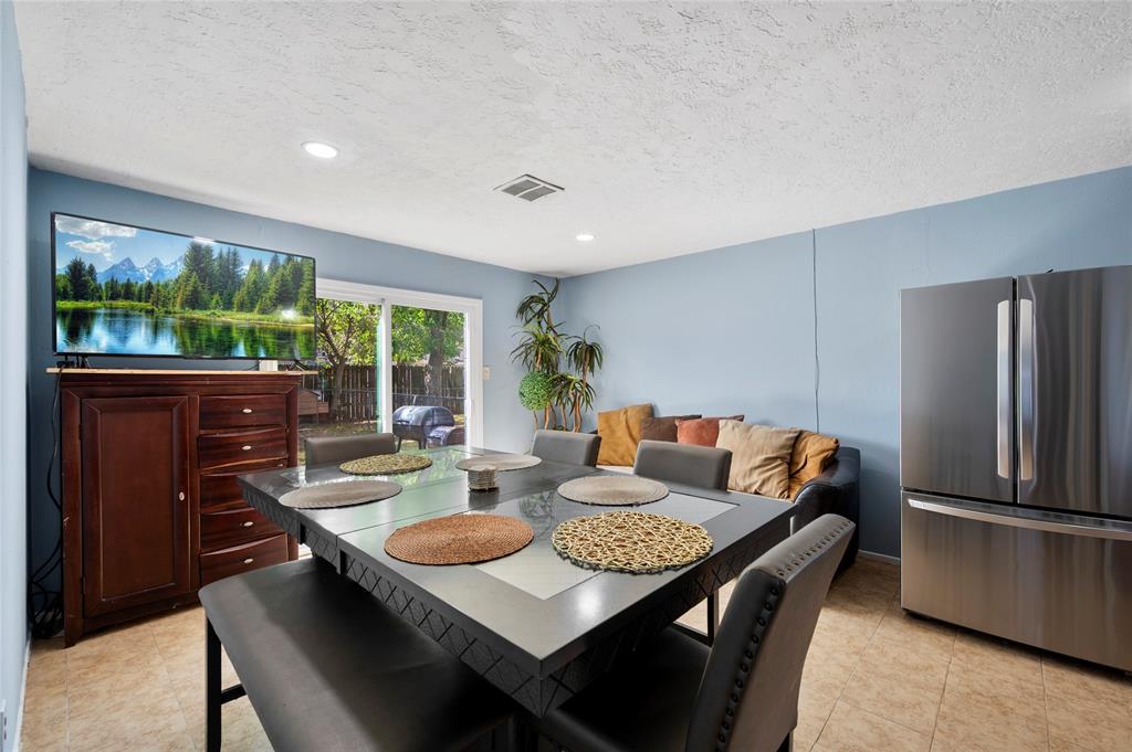 a living room with furniture and a open kitchen view