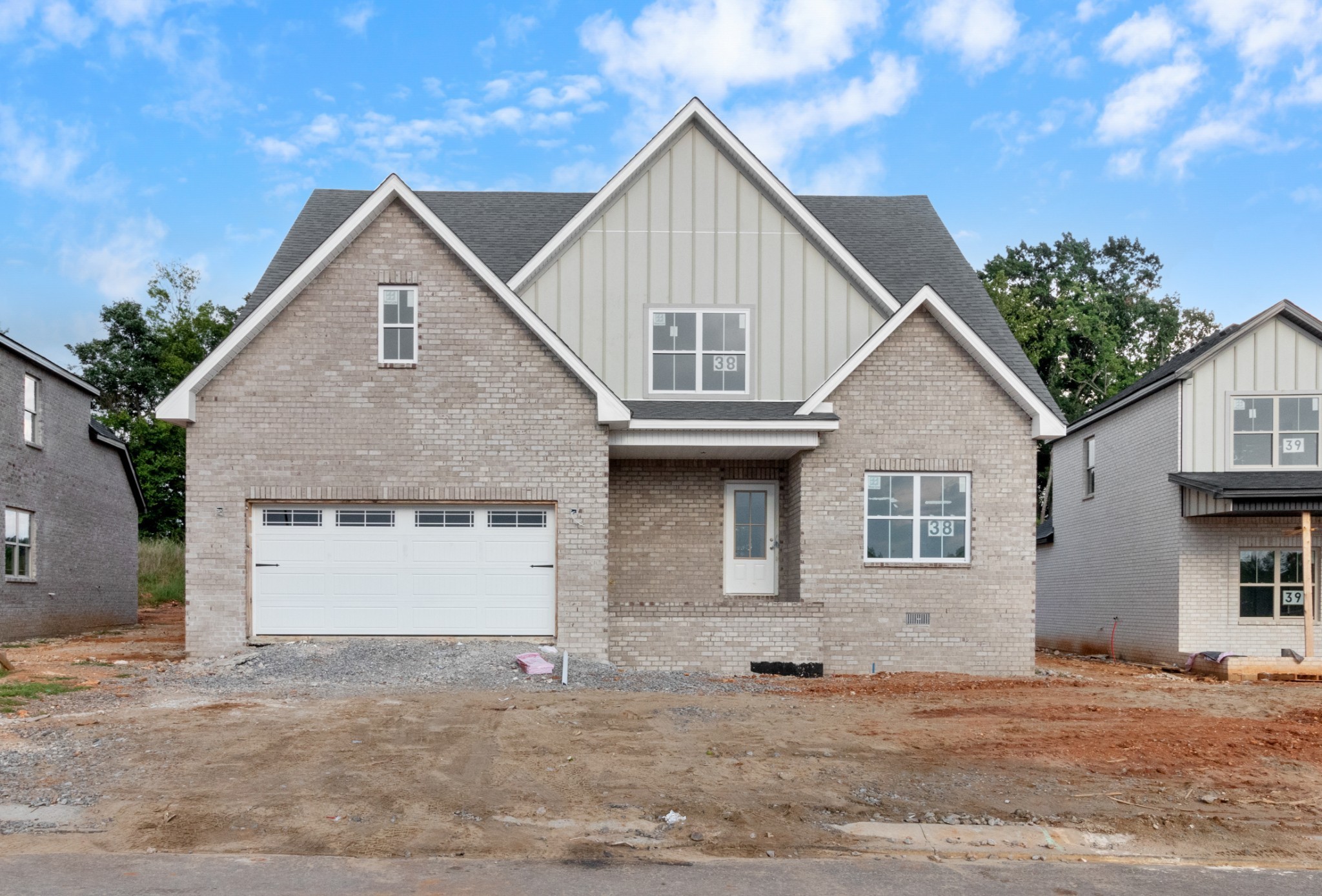 a view of a big house with a yard and garage