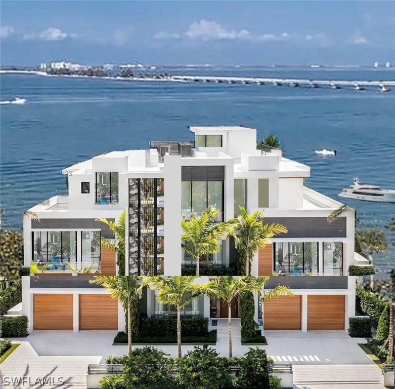 a front view of house with yard and ocean view