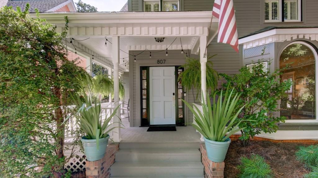 a front view of a house with plants