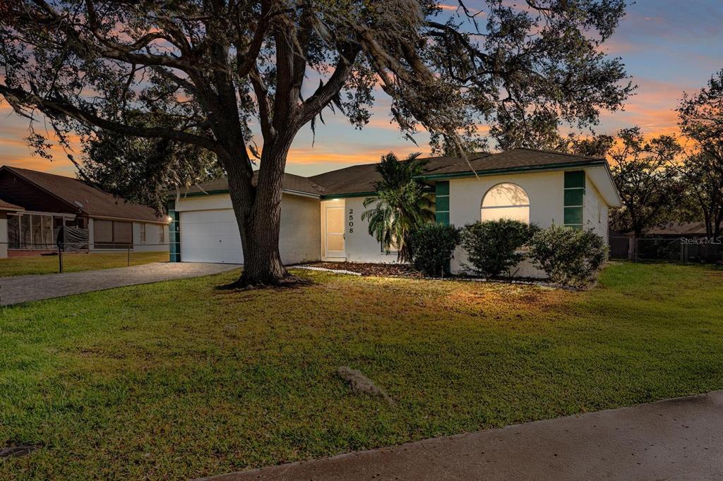 a front view of house with yard and green space