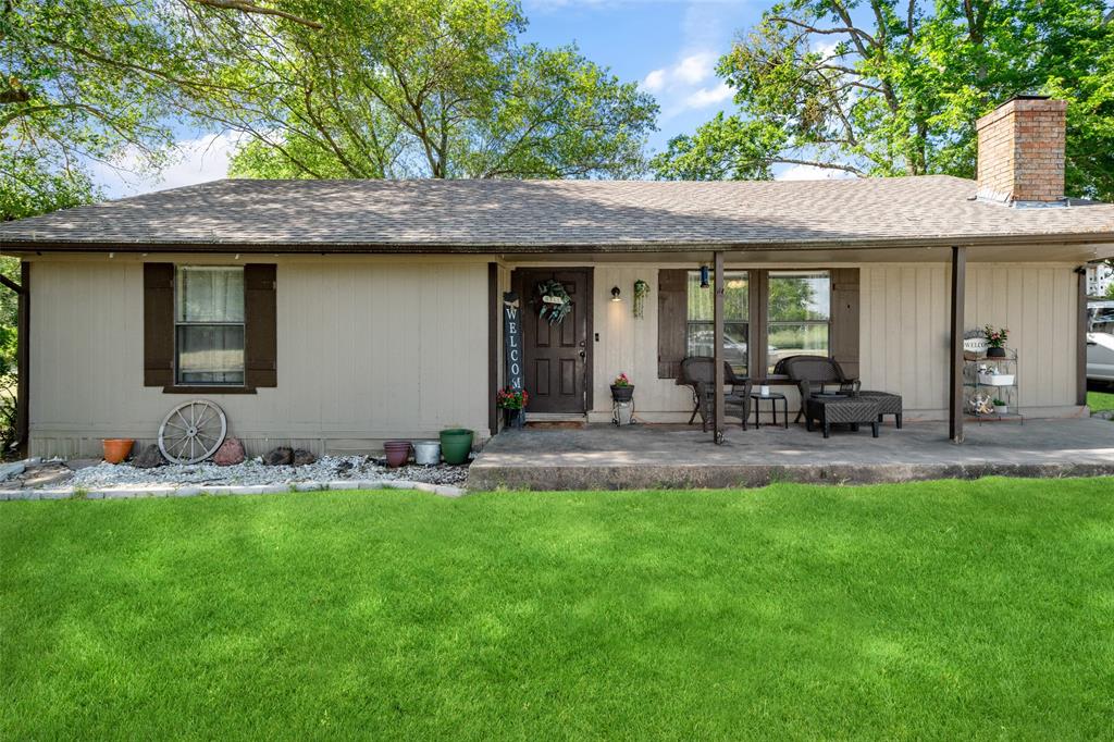 a view of a house with a yard porch and furniture