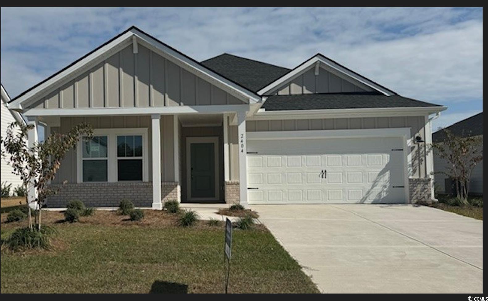 Craftsman-style home featuring a front lawn, cover