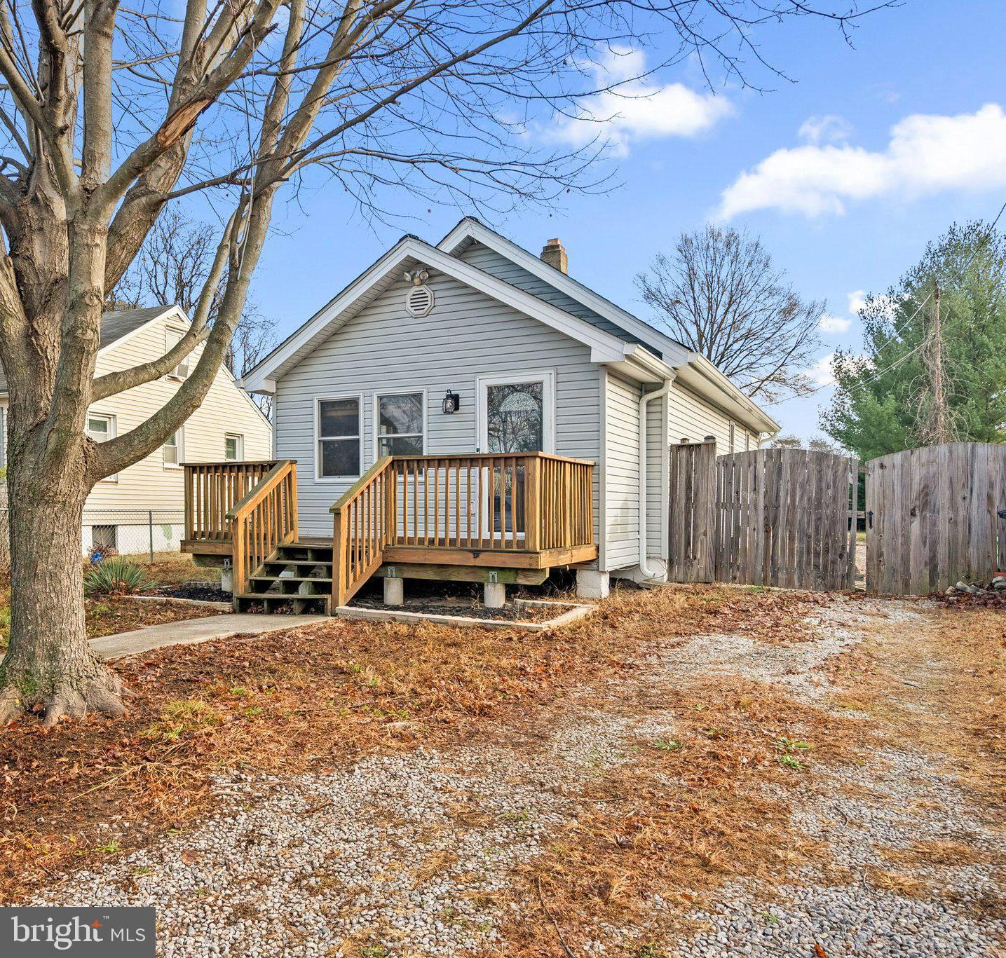 a view of a house with a yard and wooden fence