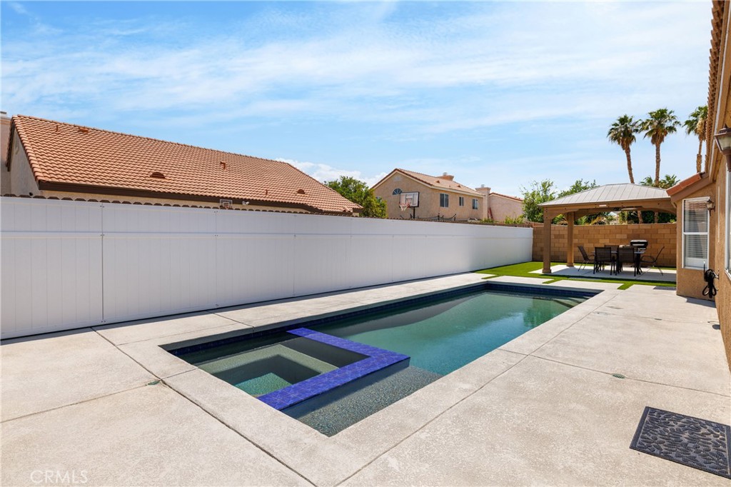 a view of swimming pool with an outdoor seating