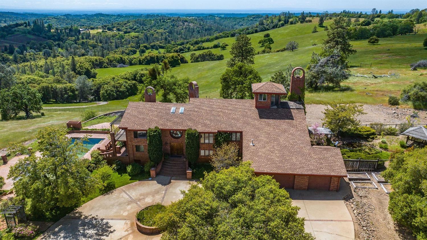 an aerial view of a house with garden space and street view