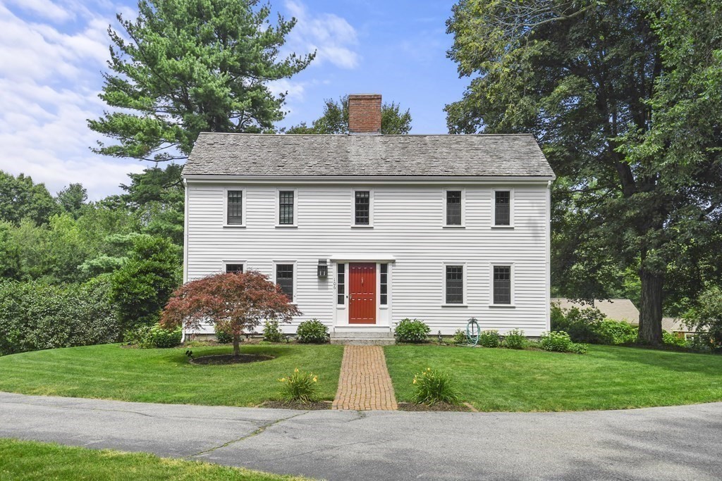 a front view of house with yard and green space