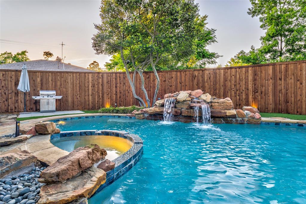 a backyard with swimming pool table and chairs