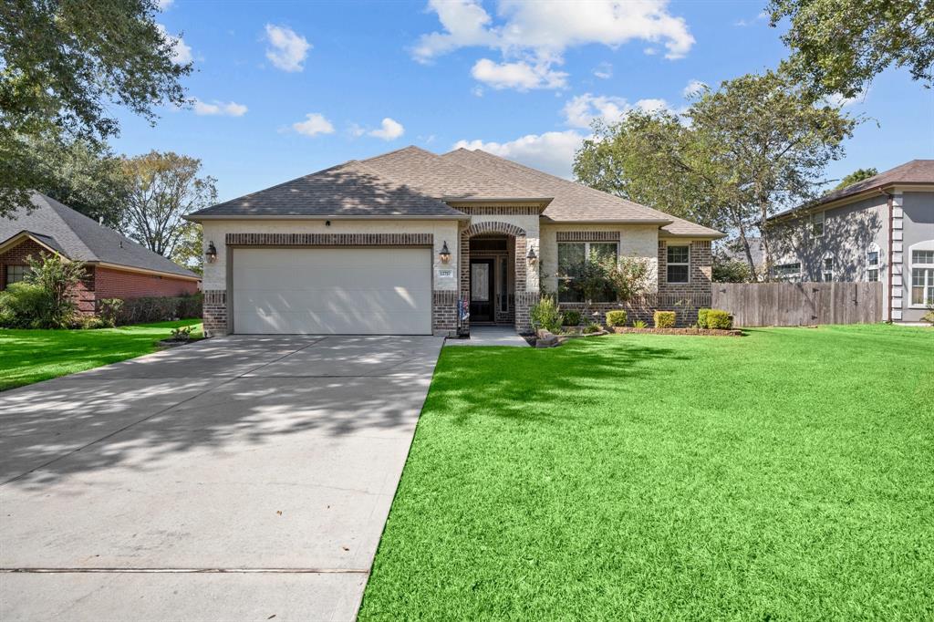 a front view of a house with a yard and garage