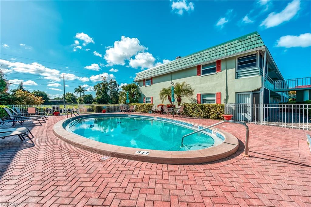 a view of a house with a swimming pool and a yard