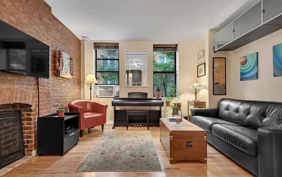 a living room with furniture fireplace and flat screen tv