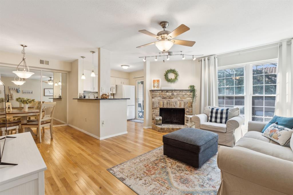 a living room with furniture fireplace and flat screen tv