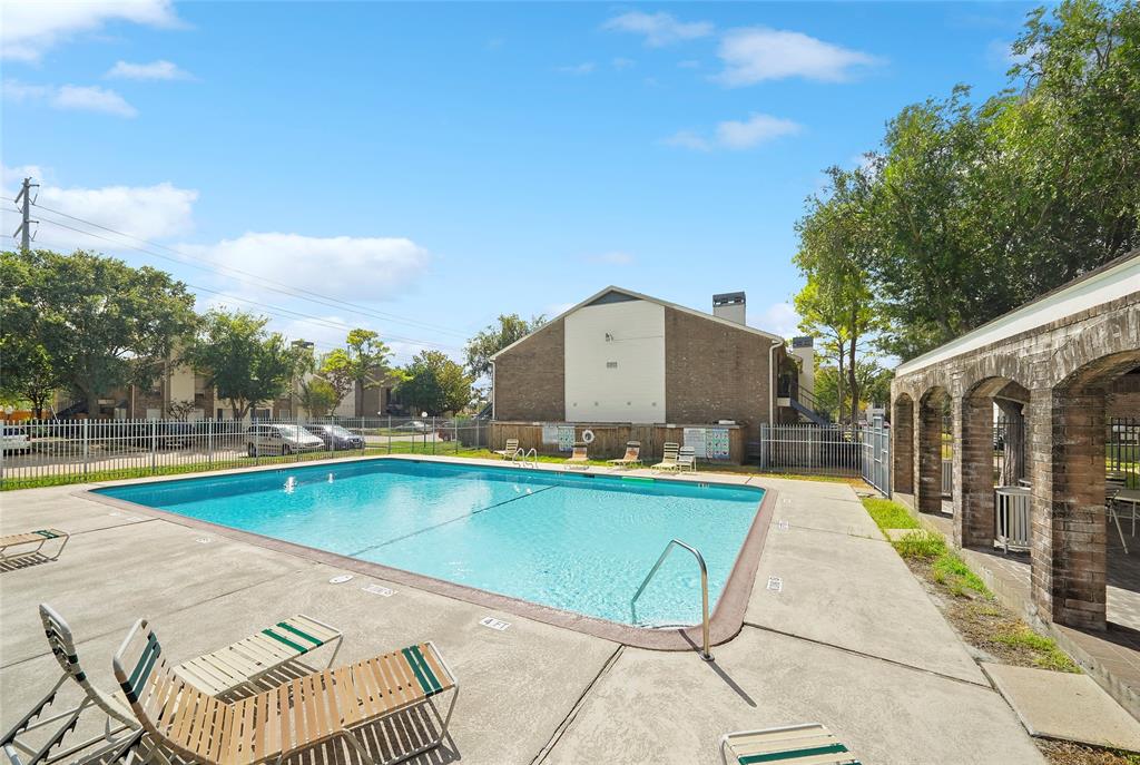 a view of a swimming pool with a lounge chairs