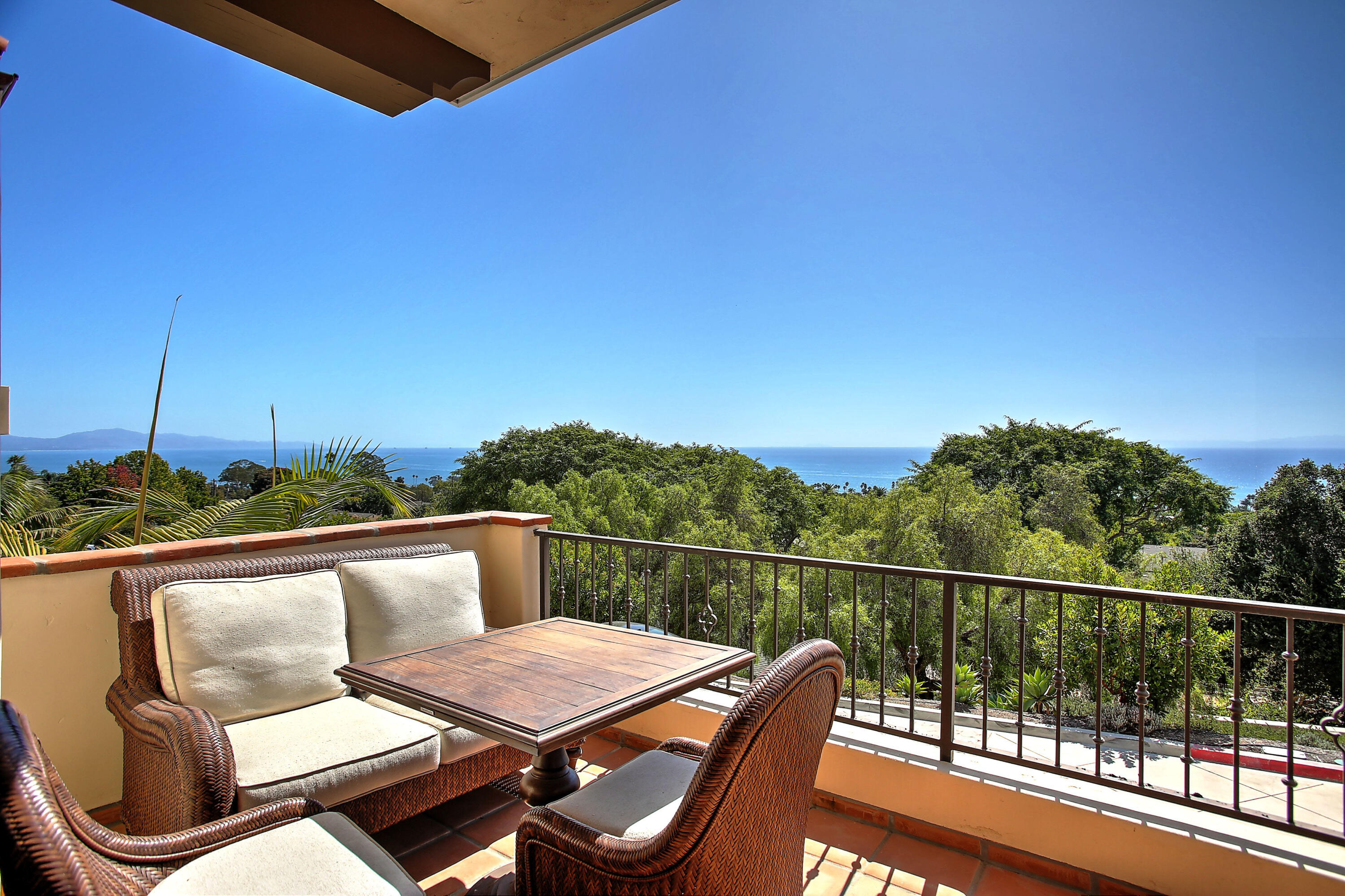 a view of a balcony with chair and wooden floor