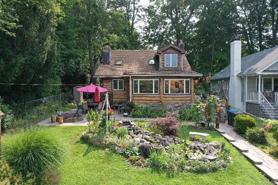 a front view of a house with a garden and plants