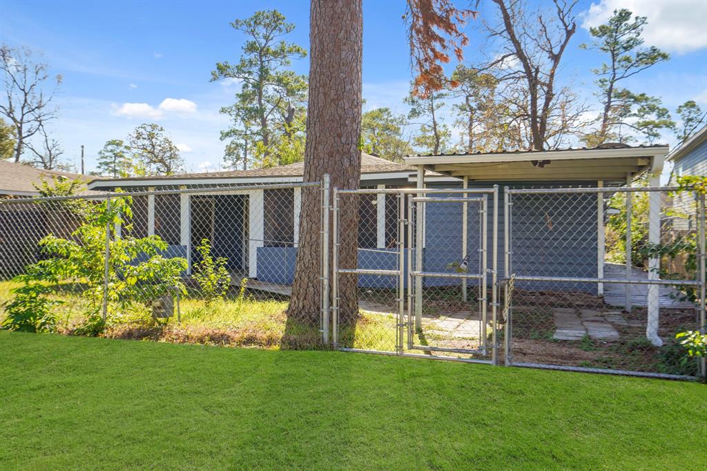 a view of house with backyard and a slide