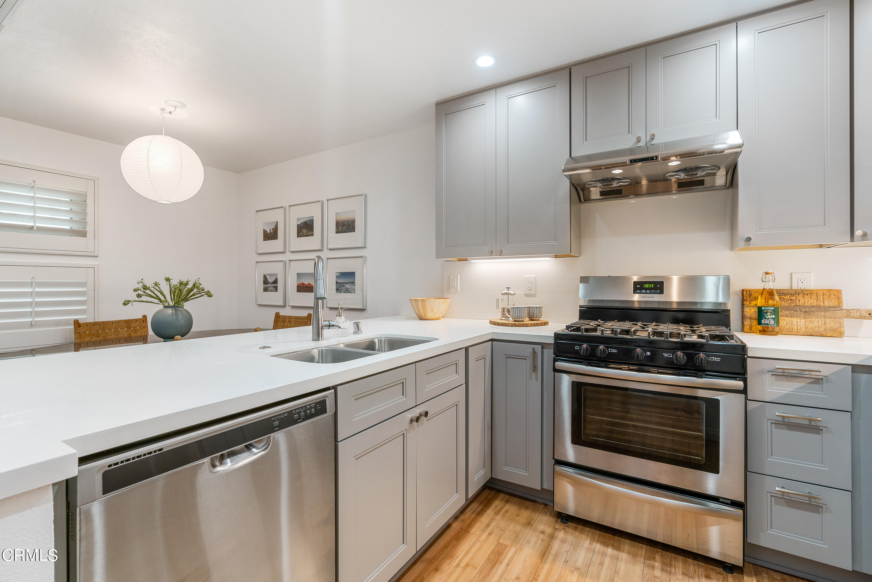 a kitchen with a stove cabinets and wooden floor