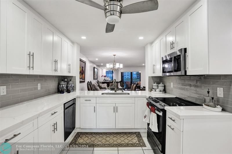 a kitchen with a sink a stove and cabinets