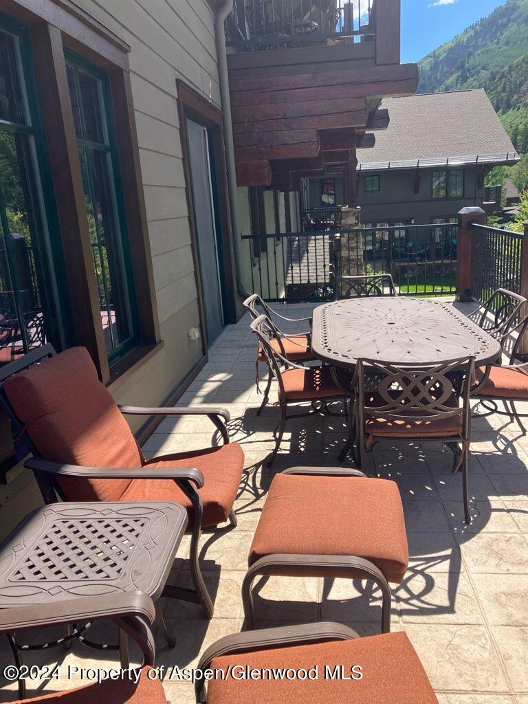 a view of a chairs and table in the balcony