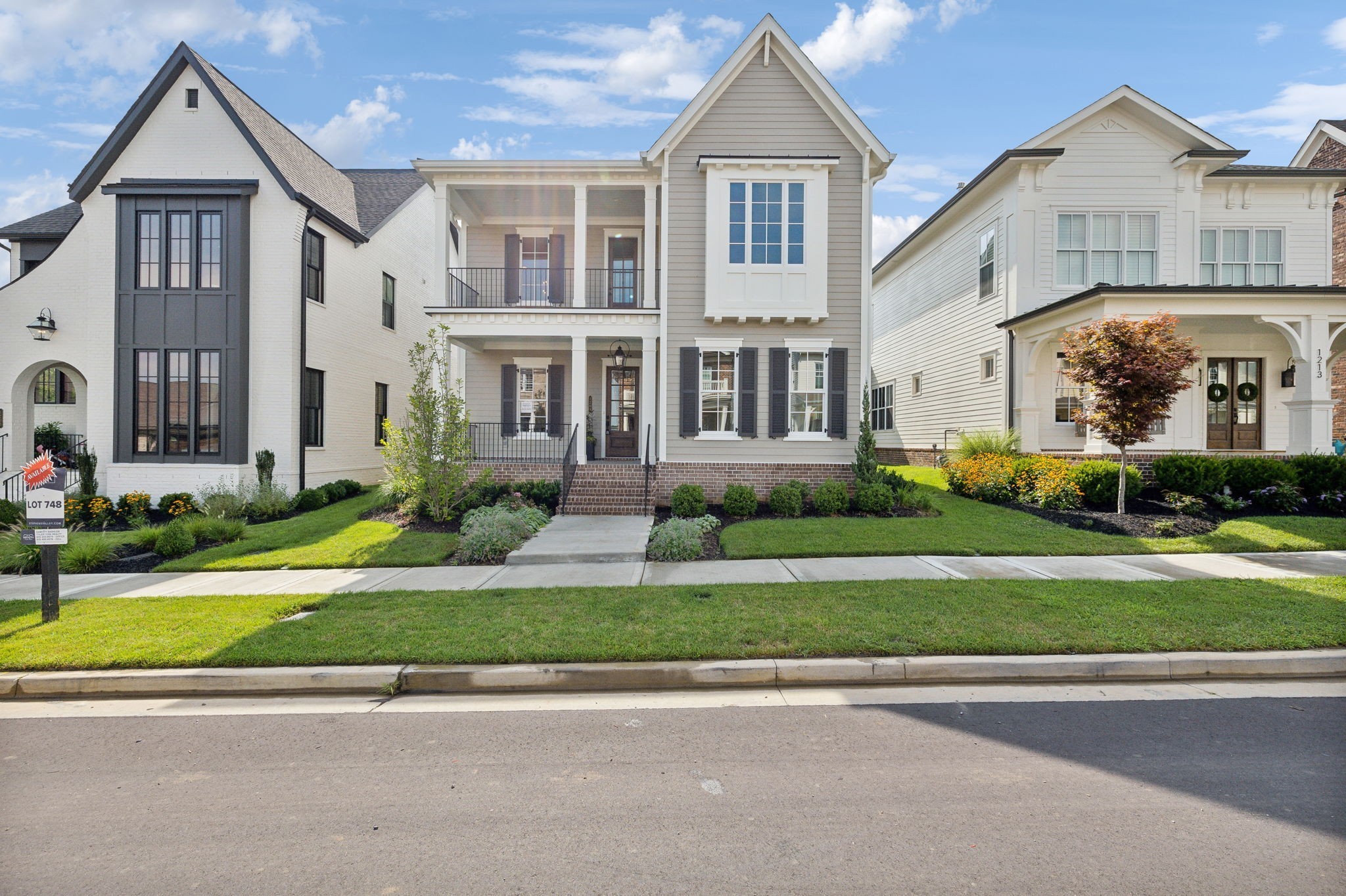 a front view of a house with a yard and a garage