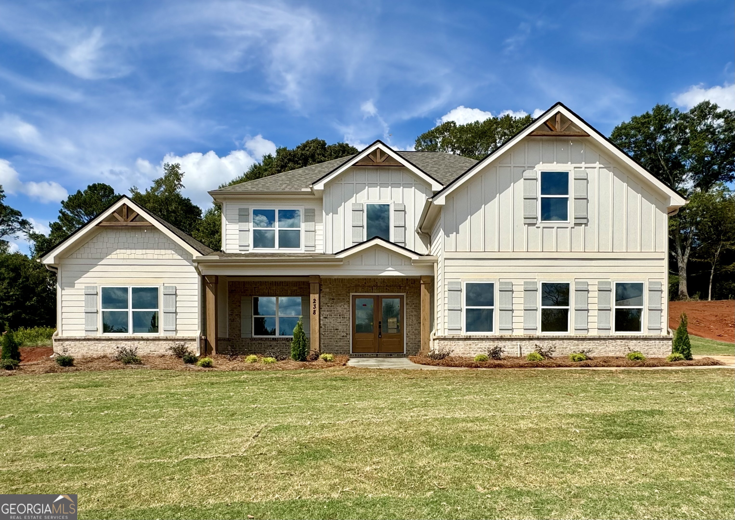 a front view of a house with a garden