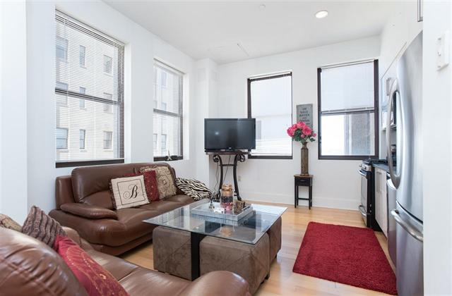 a living room with furniture fireplace and a flat screen tv